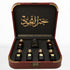Al Mayas Selection Box: Open burgundy leather box with six perfume bottles, one dokhoon jar and gold corner details